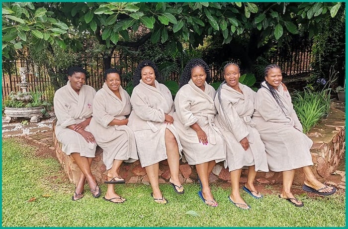 Ladies in spa gowns sitting green